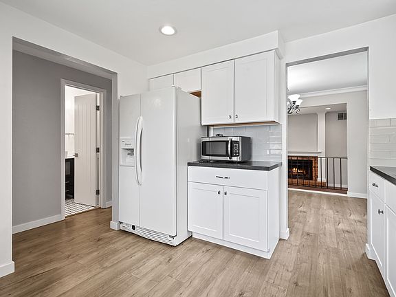 View from kitchen to 1/2 bath and dining room area