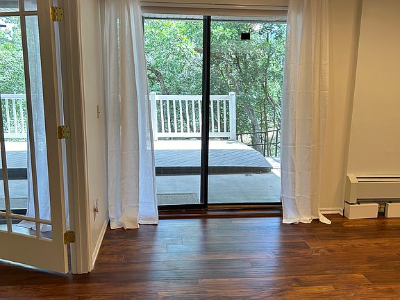 Bedroom 1 - freshly painted with a separate slider / screen door. Recently remodeled with hardwood floors & AC unit