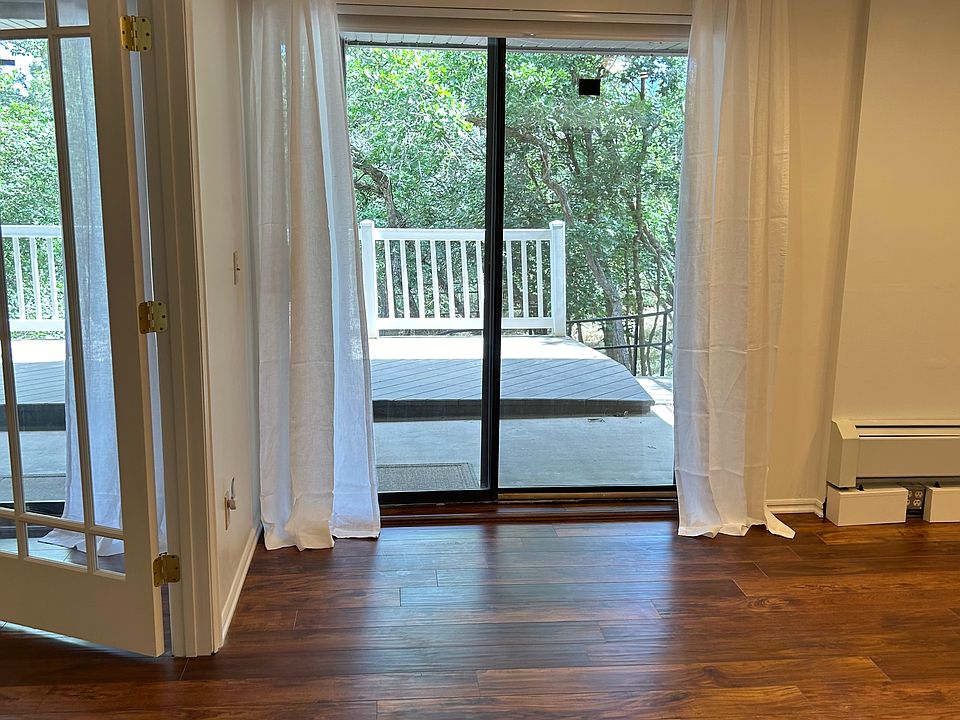 Bedroom 1 - freshly painted with a separate slider / screen door. Recently remodeled with hardwood floors & AC unit