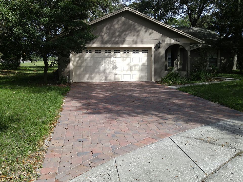 Front of home with pavered driveway