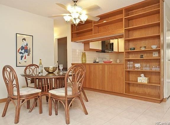 Dining area with custom hardwood built-in cabinets and shelving.