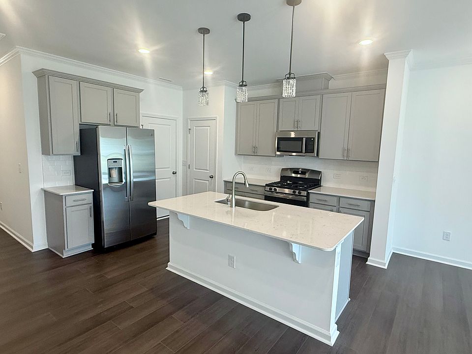 Brand new GE appliances, gas cooking, quartz countertops, subway tile backsplash, exterior ventilated microwave, garbage disposal, brand new matte black pendant lights