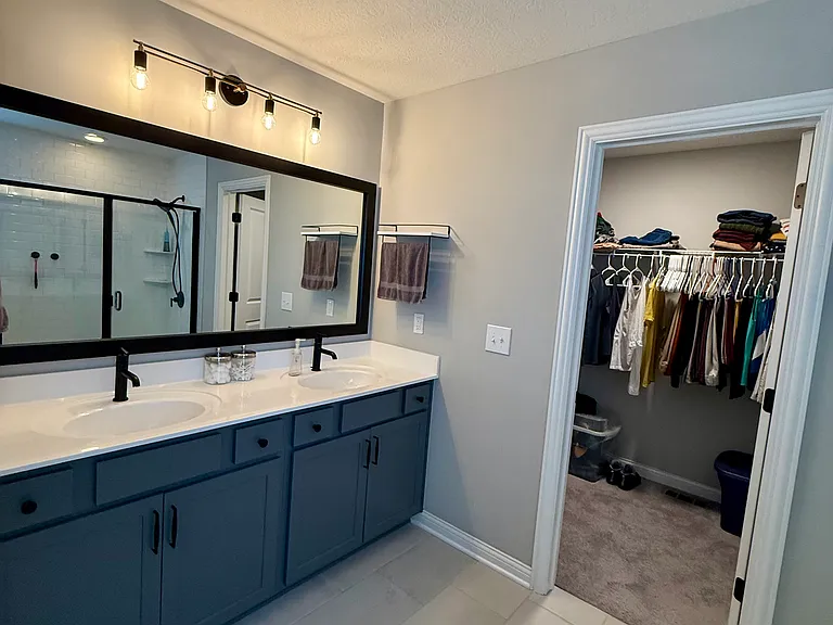 Primary bathroom attached to bedroom and leading into walk-in closet