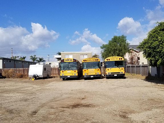 Large backyard, yellow buses are no longer there and space is available.