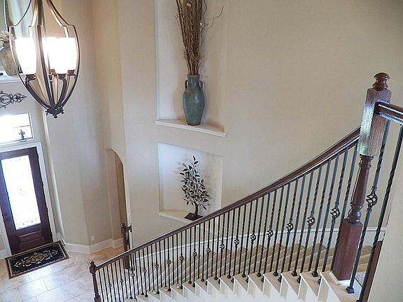 Wrought Iron spindles on the curved staircase add luxury.