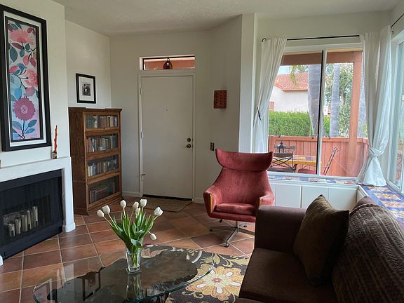 View of living room and covered patio from kitchen