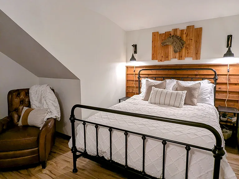 Comfortable queen bed with leather recliner sitting area