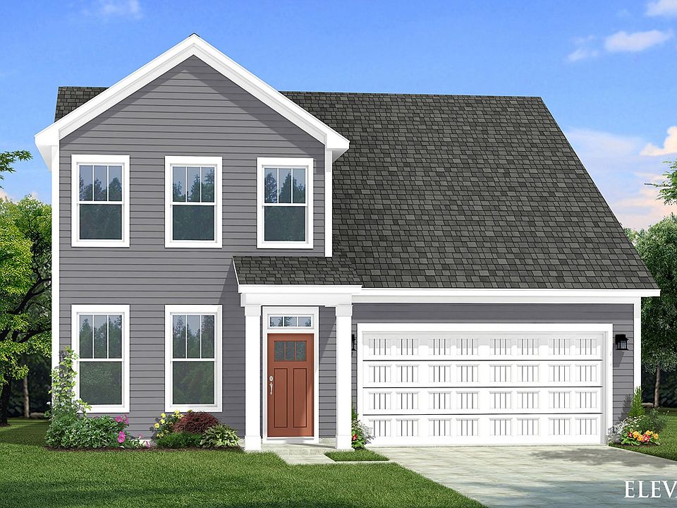 Two-story single family home with gray siding, a covered front porch and 2 car garage.