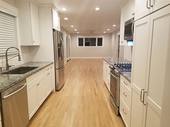 Open kitchen with all new stainless appliances, granite countertops, lots of storage