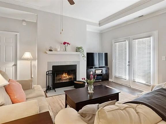 inviting living room with vinyl hardwood floors, fireplace and french doors