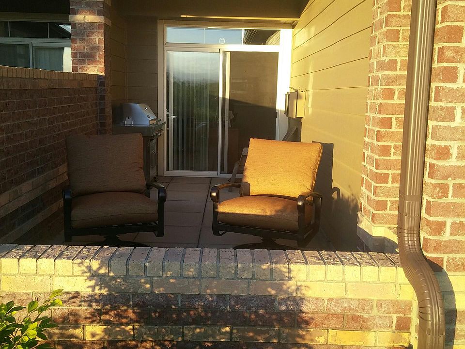 Patio with gas BBQ and storage bin for chair cushions.