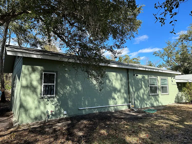 Back of Home facing water, showing walkway on West side of Home...
