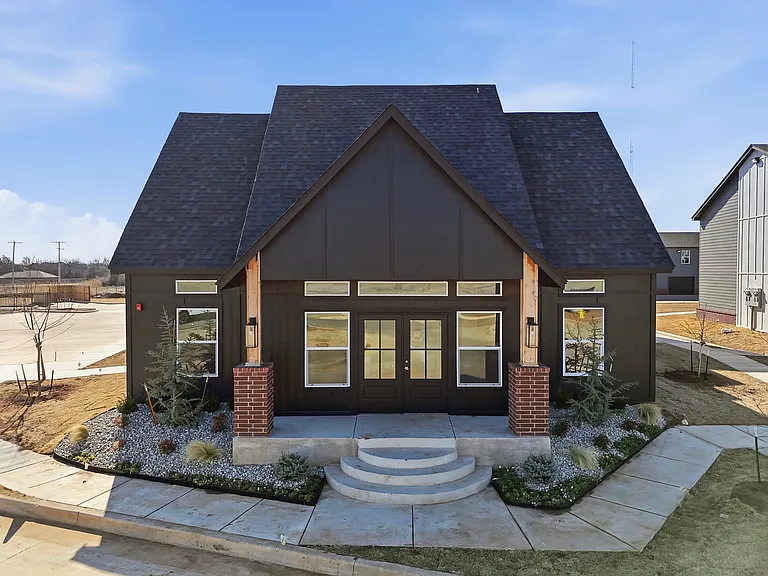 Charming modern home with stylish architecture, elegant brick accents, and inviting landscaped entrance.