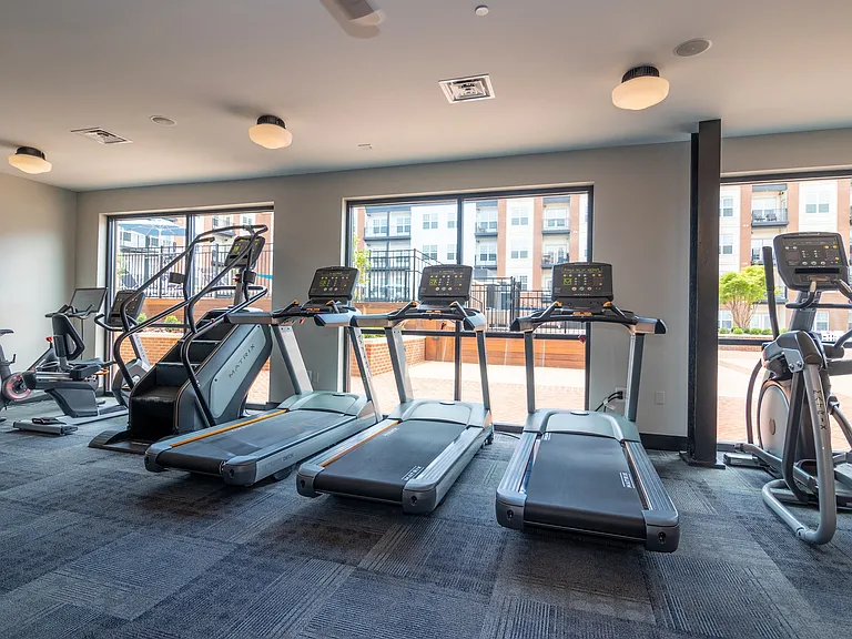 Treadmills in the Fitness Center face Penstock Quarter's bright interior courtyard.