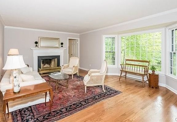 Living room with fireplace and views of pond.....
