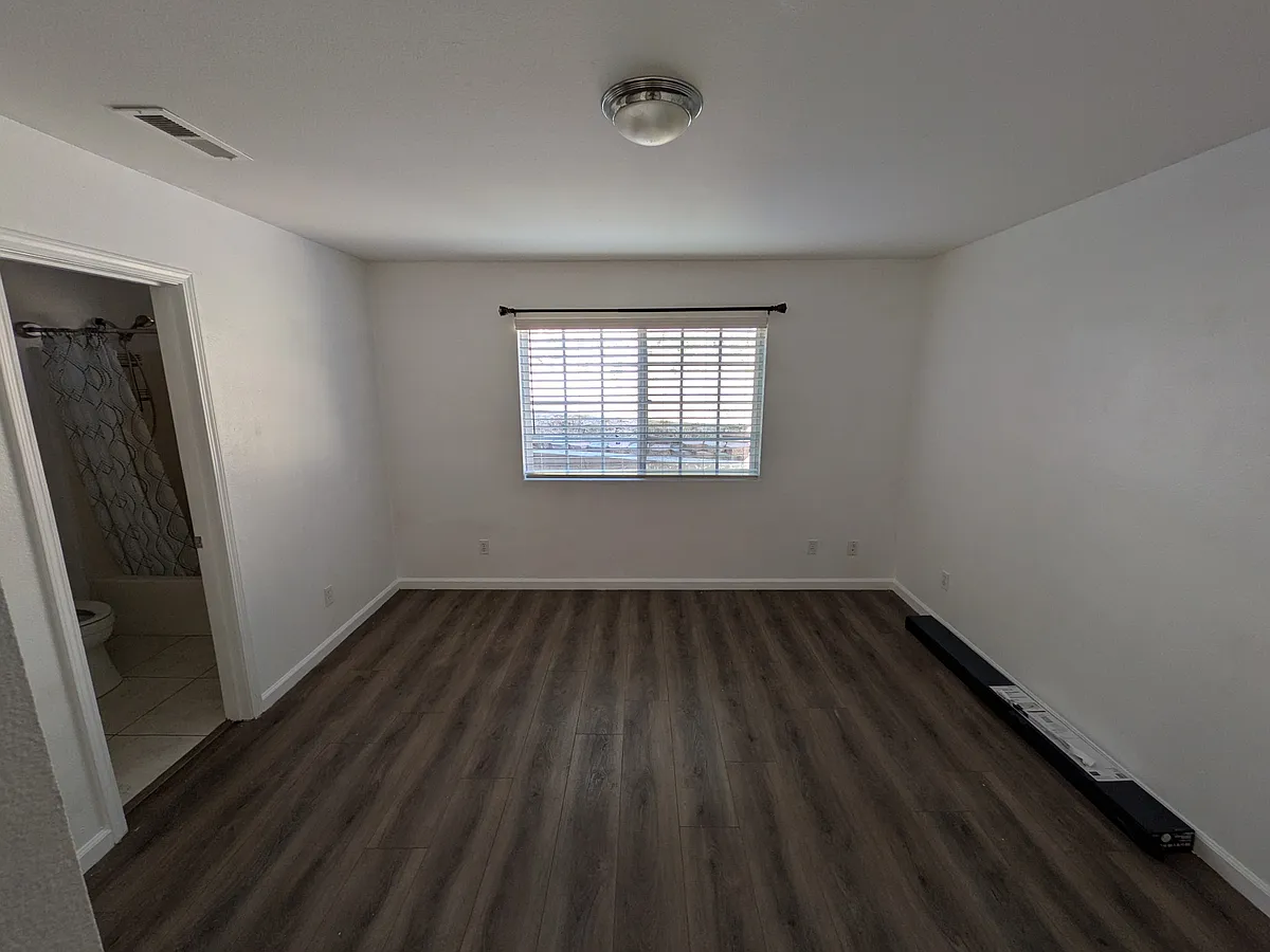 Shot of the room standing at the closet, showcasing the window and back side of the room. - 1587 Dillard St