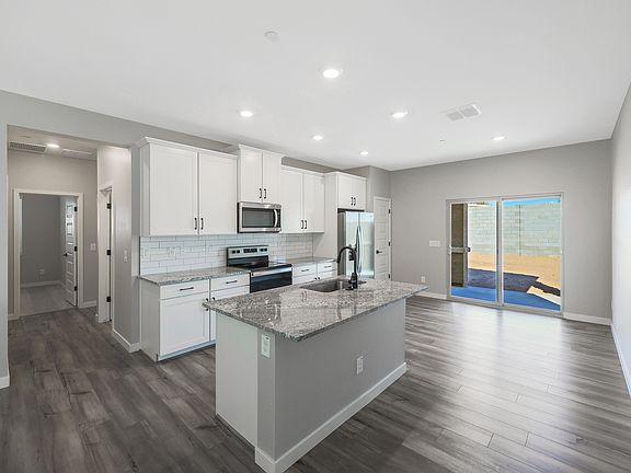 Upgraded kitchen with designer finishes, including a beautiful backsplash and granite countertops.