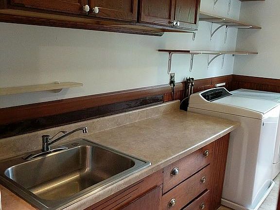 Galley kitchen with washer and dryer