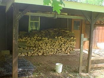 Covered area next to garage for keeping the wood dry.