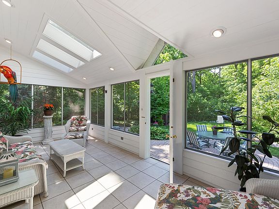 This is a WOW Room! Skylights and a wall of windows overlooking the backyard, brick patio and Lyman 