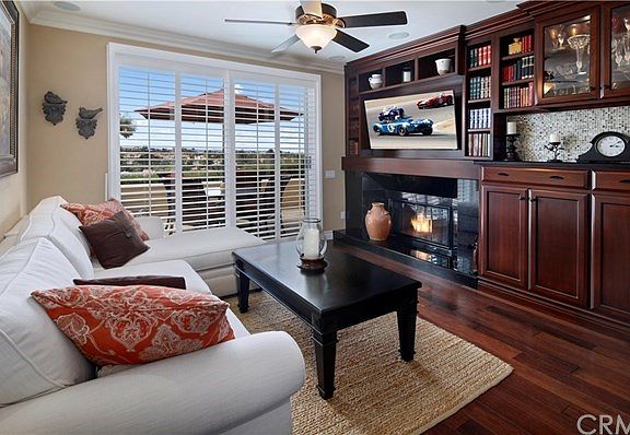 The rich, custom, built-in cabinets and fire-and-ice fireplace make this home so inviting!