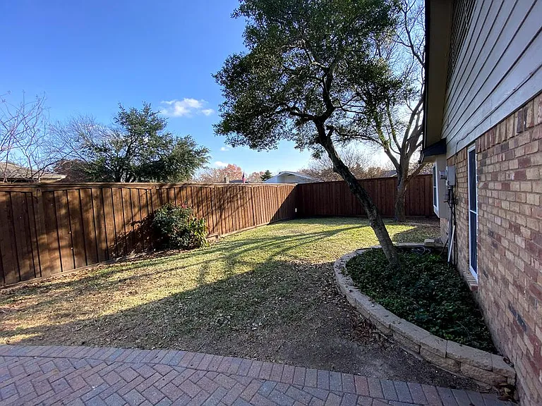 Backyard green area with 8ft privacy fence