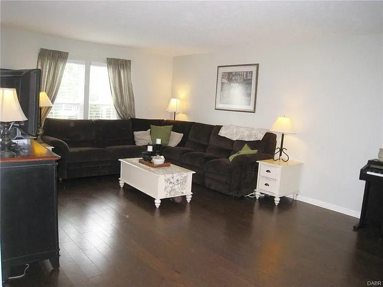 View of living room from back wall looking towards front of the home. Lots of space for families and friends to gather.