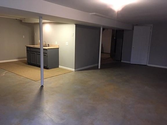 Walk out basement with plenty of daylight, stained concrete flooring/bar area, storage room and separate laundry room. Full bathroom with shower just around the bar area corner.