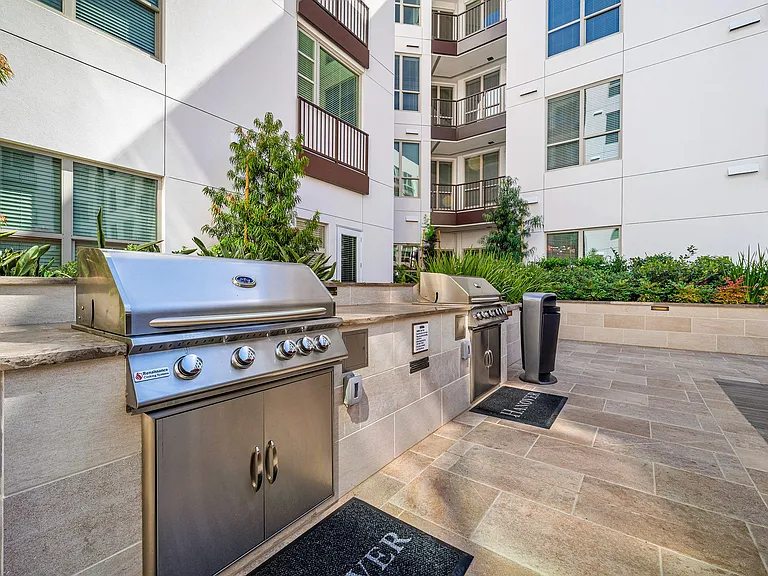 Outdoor barbecue stations with stainless steel grills in courtyards