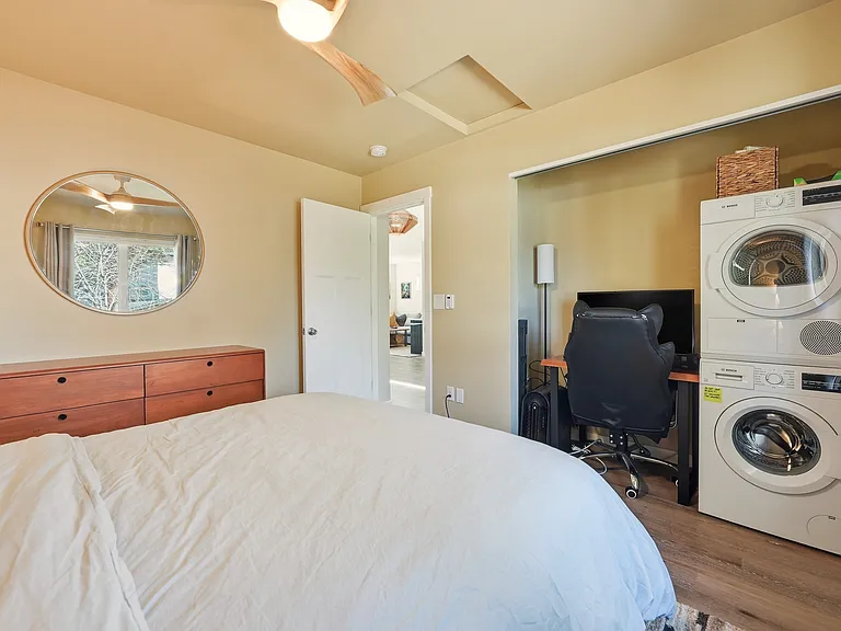 Queen bedroom in the back has a desk space. The washer/dryer is tucked away in the closet - starter supplies provided.