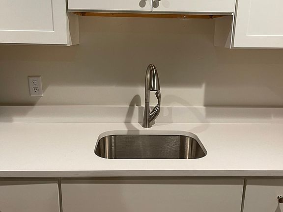 Nice deep kitchen sink with pull out faucet.