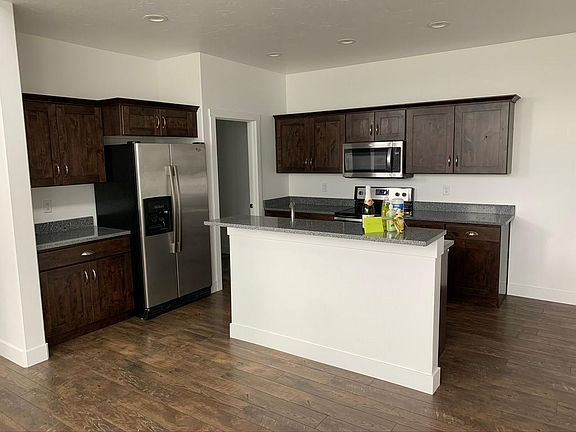 Kitchen with refrigerator, dishwasher, microwave, garbage disposal. Laundry room off of the kitchen.