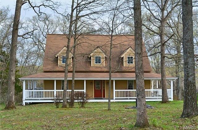 Wrap around front porch overlooking park-like front yard