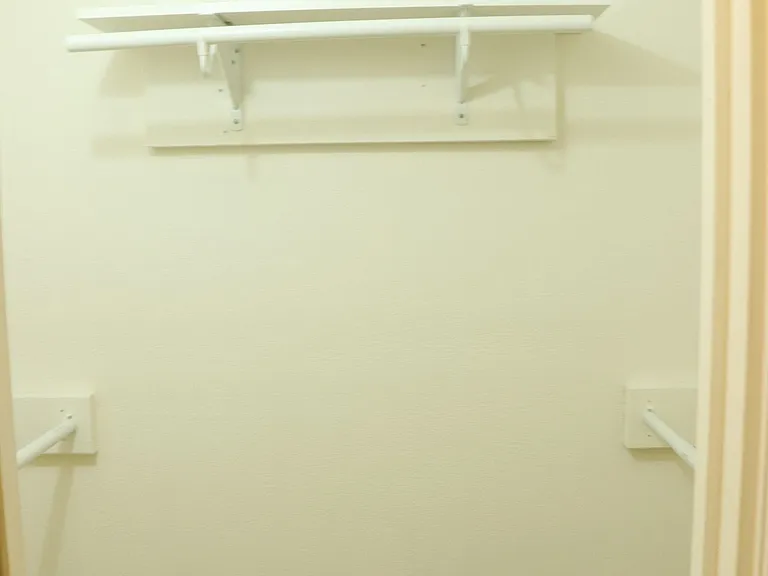 Spacious closet with hanging space and storage options.