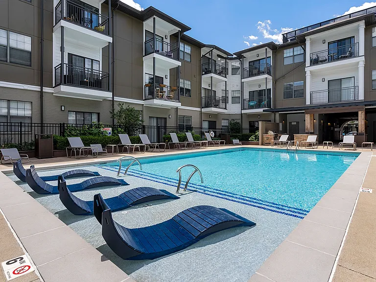 Resort style pool with in pool lounge chairs