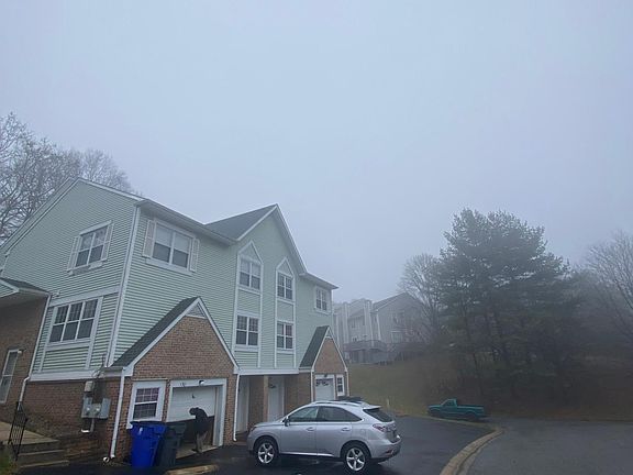 Parking garage and 2 parking space in front.