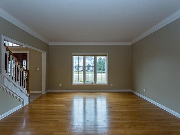 Formal living room with crown molding and gorgeous hardwood floors.
