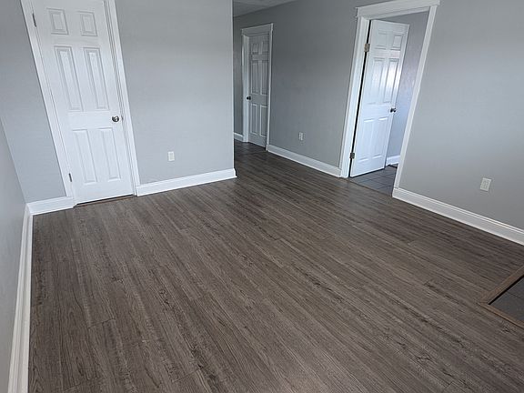 Living room with utility closet space. Door to bedroom 1