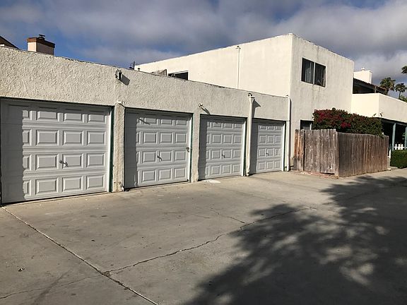 Driveway with garage next to unit