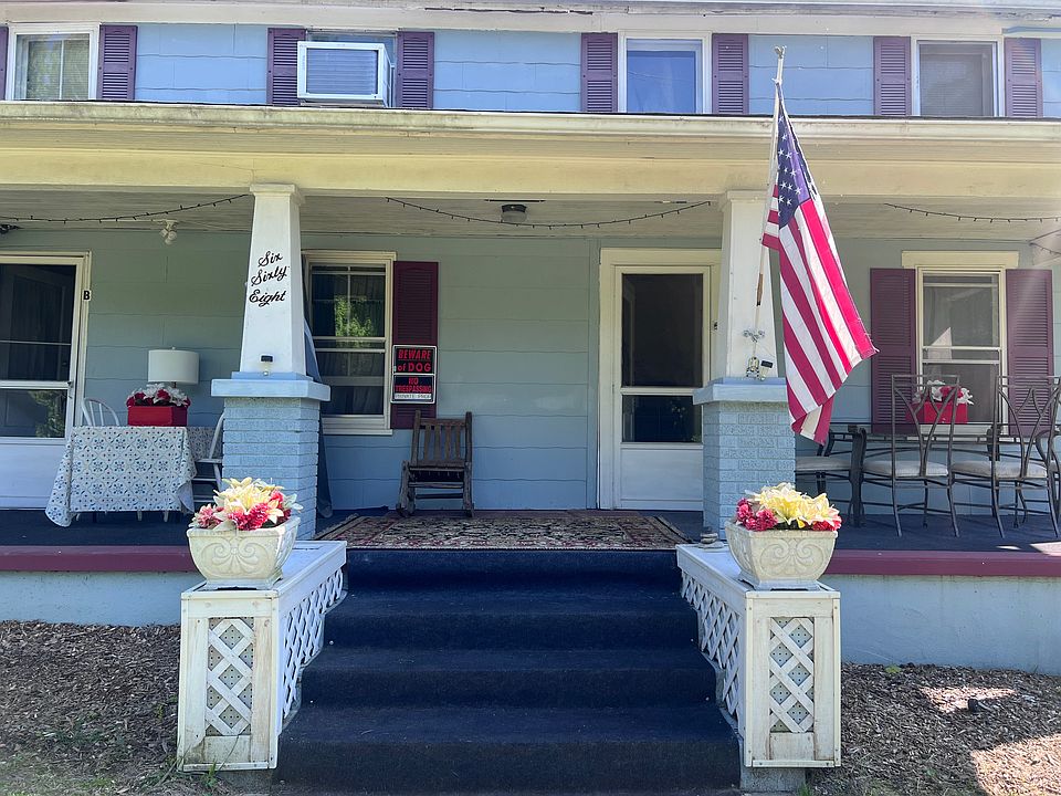 Ground level private entrance, front porch sitting area with privacy curtains