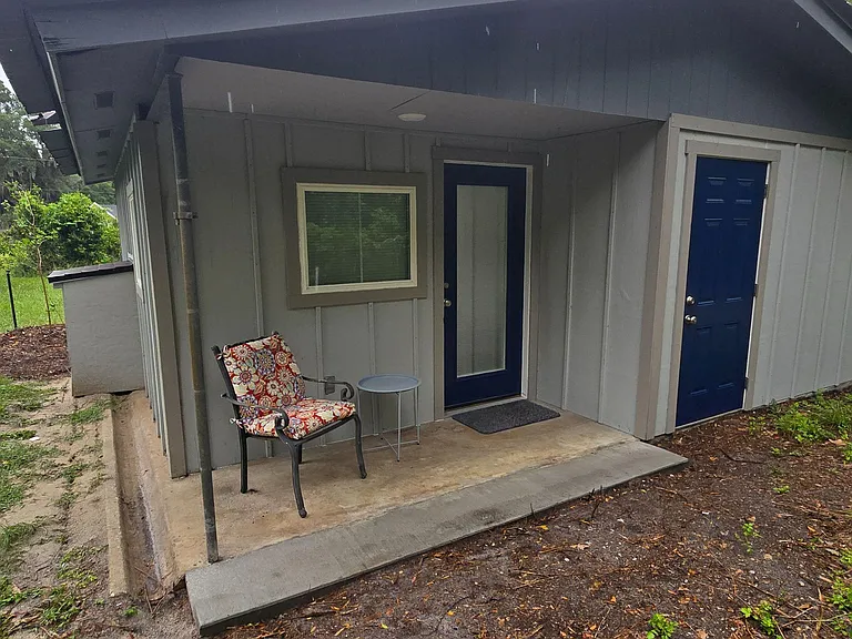 rear patio and private storage room door.