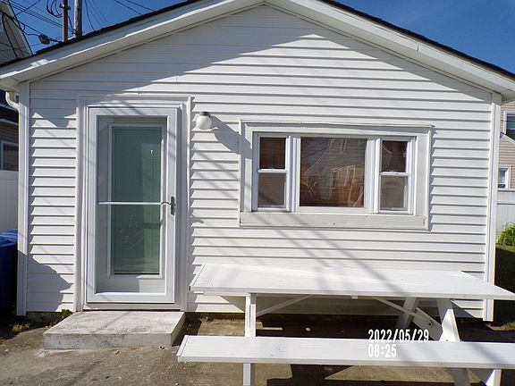 Cottage features new Andersen storm door and entry door with privacy blinds in between the glass