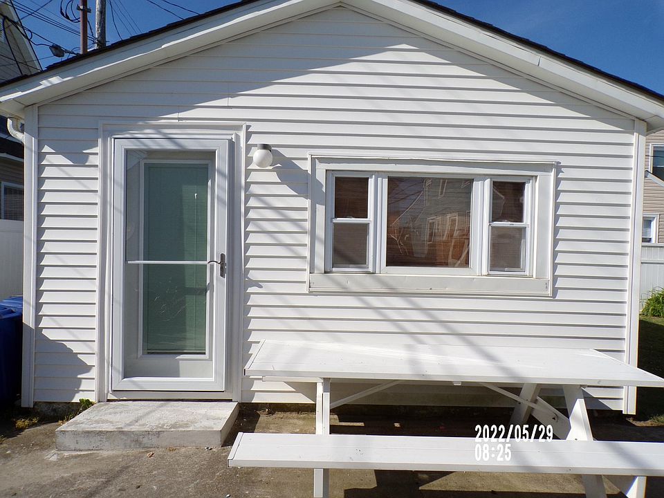 Cottage features new Andersen storm door and entry door with privacy blinds in between the glass