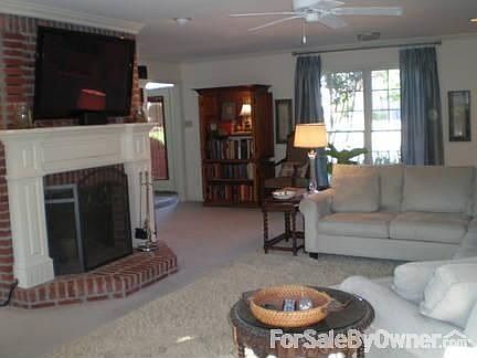 Woodburning fireplace in spacious den.