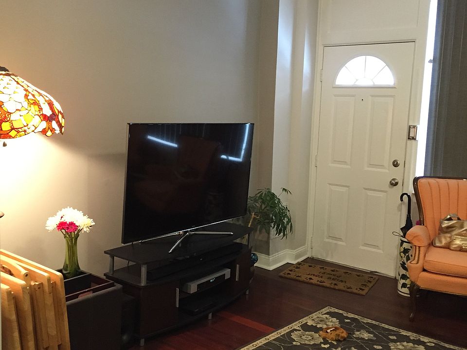 Main living area with large front window, hard wood floors,