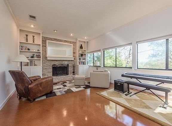 Living area 1 with fireplace, opens to backyard deck