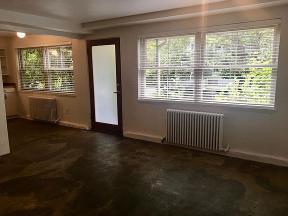 Front door and bright (double pane) windows on three sides.