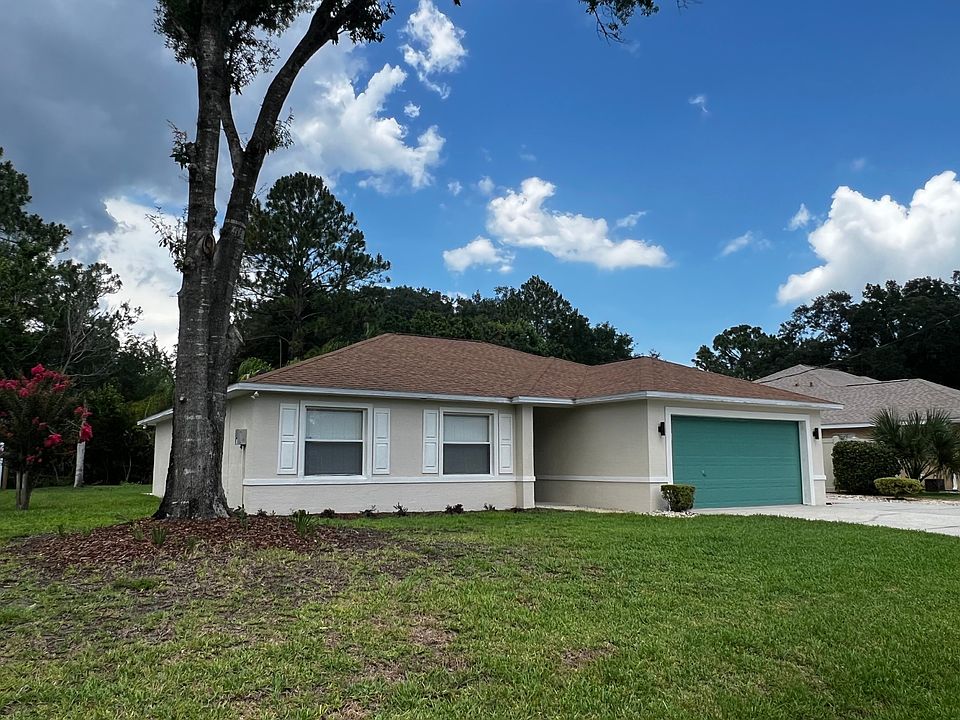The freshly painted exterior pairs beautifully with a bold, modern 2-car garage in a statement green. Manicured shrubs, crisp white trim, and new lighting make this house feel like home.