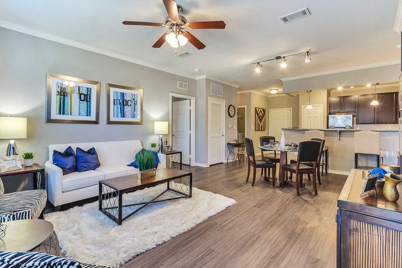 Large Living Room with open concept kitchen and ceiling fan and hard wood floors