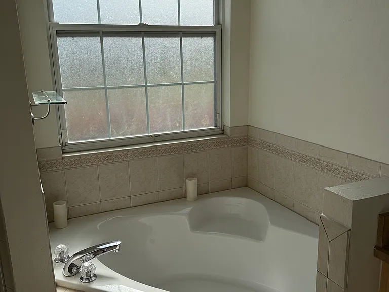 Master bathroom has side by side vanities, additional linen closet for stage, soaking tub, and separate walk-in shower.
